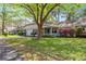 Landscaped front exterior of a home with a garage, covered porch, and pretty flowering bushes at 8700 Sw 98Th Street Rd # E, Ocala, FL 34481