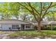 Home exterior with a covered front porch, attached garage, and tidy landscaping at 8700 Sw 98Th Street Rd # E, Ocala, FL 34481