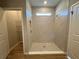 New bathroom featuring a tiled shower with a small window for natural light and a walk-in closet at 9975 Sw 39Th Ter, Ocala, FL 34476