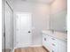 Modern bathroom features a double sink vanity with quartz countertops, glass-enclosed shower and tile flooring at 9975 Sw 39Th Ter, Ocala, FL 34476