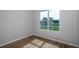 Bedroom featuring wood-look vinyl flooring, a large window with an outside view, and neutral paint at 9975 Sw 39Th Ter, Ocala, FL 34476