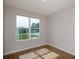 Bedroom featuring wood-look vinyl flooring, a window with an outside view, and neutral paint at 9975 Sw 39Th Ter, Ocala, FL 34476