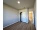 Bedroom features durable wood-look vinyl flooring, a closet with doors, and interior doors at 9975 Sw 39Th Ter, Ocala, FL 34476