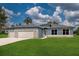 Beautiful single Gathering home featuring a stone accent, well maintained lawn, and neutral blue paint at 9975 Sw 39Th Ter, Ocala, FL 34476