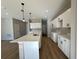 The open kitchen features white cabinets, a large island with a sink, and recessed lighting at 9975 Sw 39Th Ter, Ocala, FL 34476