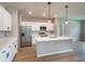 Bright kitchen features an island with pendant lighting, stainless steel appliances, and white cabinets at 9975 Sw 39Th Ter, Ocala, FL 34476