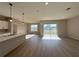 Open concept living area with bright lighting, light wood flooring, and sliding glass doors at 9975 Sw 39Th Ter, Ocala, FL 34476