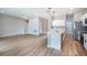 Open concept living area featuring hardwood floors, recessed lighting, and a view to the kitchen at 9975 Sw 39Th Ter, Ocala, FL 34476
