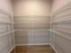 Walk-in closet with wire shelving and wood-look flooring at 9975 Sw 39Th Ter, Ocala, FL 34476