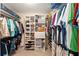 Walk-in closet offers ample storage with custom shelving and hanging space for clothes and accessories at 1913 Augustine Dr, The Villages, FL 32159