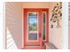 Close-up of a decorative glass front door with sidelight and outdoor wall decor at 1913 Augustine Dr, The Villages, FL 32159