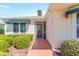 Inviting front entrance with a decorative screen door and manicured landscaping at 1913 Augustine Dr, The Villages, FL 32159