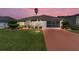 Charming single-story home with manicured lawn, vibrant landscaping, and a private driveway at 1913 Augustine Dr, The Villages, FL 32159
