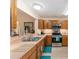 Well-lit kitchen featuring stainless steel appliances and light wood cabinetry at 1913 Augustine Dr, The Villages, FL 32159