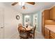 Sunny eat-in kitchen area features a ceiling fan and neutral decor at 1913 Augustine Dr, The Villages, FL 32159