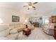 Inviting living room with vaulted ceiling and open layout leading to the dining area and front door at 1913 Augustine Dr, The Villages, FL 32159