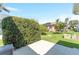 Back patio with a privacy hedge and view of a well-maintained lawn at 1913 Augustine Dr, The Villages, FL 32159