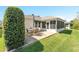 Cozy patio features an outdoor dining set and lush landscaping at 1913 Augustine Dr, The Villages, FL 32159