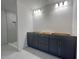 Bathroom with a double vanity, modern fixtures, and a tiled walk-in shower at 4365 Sw 90Th Pl, Ocala, FL 34476