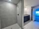 Modern bathroom featuring a tiled shower, granite counters, and stylish vanity at 4365 Sw 90Th Pl, Ocala, FL 34476