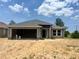 An unfinished single-story home featuring a two-car garage and a covered entryway at 4365 Sw 90Th Pl, Ocala, FL 34476