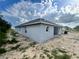 View of single story home with gray exterior, a covered patio, and a well maintained yard at 4365 Sw 90Th Pl, Ocala, FL 34476