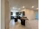 Corner view of modern kitchen showcasing dark cabinets and an island with granite countertops at 4365 Sw 90Th Pl, Ocala, FL 34476
