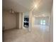 Open concept living room with tile floors, modern lighting, and views of the backyard at 4365 Sw 90Th Pl, Ocala, FL 34476