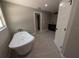 Bathroom featuring a modern freestanding tub and a granite-topped vanity at 6150 Sw 123 Ave Rd, Dunnellon, FL 34432