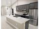 Gourmet kitchen with large island, stainless steel appliances, and modern pendant lighting at 6150 Sw 123 Ave Rd, Dunnellon, FL 34432