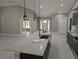 Open concept kitchen with island, sink and quartz countertops, and pendant lights at 6150 Sw 123 Ave Rd, Dunnellon, FL 34432