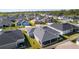 Aerial view of a neighborhood featuring many homes with screened-in patios and manicured lawns at 6877 Minchew Cir, The Villages, FL 34762