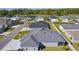 Aerial view of a home featuring a gray shingled roof and a view of the neighborhood at 6877 Minchew Cir, The Villages, FL 34762