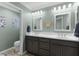 Bathroom featuring double sinks, modern vanity, and framed mirrors at 6877 Minchew Cir, The Villages, FL 34762