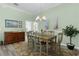 Elegant dining area featuring a stylish chandelier and a view into other rooms at 6877 Minchew Cir, The Villages, FL 34762