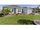 Landscaped front lawn with flower beds and well manicured shrubbery at 6877 Minchew Cir, The Villages, FL 34762