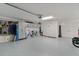 Well-organized garage features epoxy floors, storage cabinets, and plenty of room for tools and equipment at 6877 Minchew Cir, The Villages, FL 34762