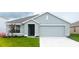 Charming single-story home with an attached two-car garage and a well-maintained front lawn at 7121 Se 113Th Ln, Belleview, FL 34420