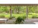 Relaxing back porch overlooking a lush yard with mature trees and decorative landscaping at 760 Sw 89Th Ter, Ocala, FL 34481