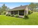 Backyard view of a screened-in porch with a jacuzzi, perfect for relaxation and entertaining at 760 Sw 89Th Ter, Ocala, FL 34481