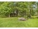 Lush acreage with mature shade trees, landscaping, and backyard furniture at 760 Sw 89Th Ter, Ocala, FL 34481