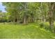 Expansive green lot with mature trees, landscaping and decorative accents at 760 Sw 89Th Ter, Ocala, FL 34481