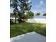 Expansive grassy backyard featuring a white vinyl fence and lush greenery at 845 Ne 130 Ter, Silver Springs, FL 34488