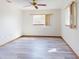 Bright bedroom showcasing wood laminate flooring, a ceiling fan, and natural light from multiple windows at 11197 Sw 79Th Ave, Ocala, FL 34476