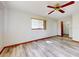 Bedroom featuring wood-look flooring, ceiling fan, one window and closet entryway at 11197 Sw 79Th Ave, Ocala, FL 34476