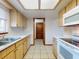 Galley kitchen with wood cabinets, white countertops, and tile flooring at 11197 Sw 79Th Ave, Ocala, FL 34476
