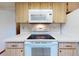 Close-up of the kitchen featuring appliances including microwave and oven at 11197 Sw 79Th Ave, Ocala, FL 34476