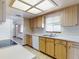 View of the kitchen featuring light wood cabinets, white countertops, and tiled backsplash at 11197 Sw 79Th Ave, Ocala, FL 34476