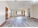 Open living room featuring tile and laminate floors, bright light fixture and multiple windows bringing natural light in at 11197 Sw 79Th Ave, Ocala, FL 34476