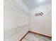 Walk-in closet featuring laminate floors and built-in wire shelving for organization and storage at 11197 Sw 79Th Ave, Ocala, FL 34476